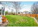 Well-maintained backyard featuring green grass, wooden fence and an open lawn at 3865 Rawhide Cir, Castle Rock, CO 80104