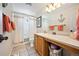 Cozy bathroom featuring tile flooring, wood vanity, and shower with white curtain at 3865 Rawhide Cir, Castle Rock, CO 80104