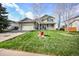 Charming two-story home with a well-maintained lawn and inviting front porch at 3865 Rawhide Cir, Castle Rock, CO 80104