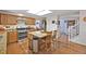 Bright kitchen featuring stainless steel appliances, wood cabinets, and a kitchen island with barstool seating at 3865 Rawhide Cir, Castle Rock, CO 80104