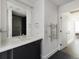 Clean, modern bathroom with white vanity, stylish heated towel rack, and large mirror at 55 W 12Th Ave # 510, Denver, CO 80204