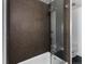Elegant bathroom with glass-enclosed shower and stylish brown tiled walls at 55 W 12Th Ave # 510, Denver, CO 80204