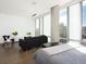 Sleek bedroom boasting city views through expansive windows and hardwood flooring at 55 W 12Th Ave # 510, Denver, CO 80204