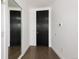 Modern hallway featuring hardwood floors, white walls, and dark wood doors at 55 W 12Th Ave # 510, Denver, CO 80204