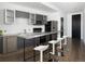 Contemporary kitchen features a stainless steel island, gray cabinets and stainless steel appliances at 55 W 12Th Ave # 510, Denver, CO 80204