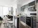 Modern kitchen with stainless steel appliances, gray cabinets, and a breakfast bar with seating at 55 W 12Th Ave # 510, Denver, CO 80204