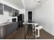 Contemporary kitchen with stainless steel appliances, light gray cabinetry, and a long breakfast bar at 55 W 12Th Ave # 510, Denver, CO 80204