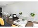 Contemporary living room with hardwood floors, plants, a white accent wall, and stylish furniture at 55 W 12Th Ave # 510, Denver, CO 80204