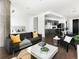Open-concept living area with a modern sofa and a view into the kitchen and bedroom at 55 W 12Th Ave # 510, Denver, CO 80204