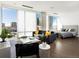 Bright open floor plan features a comfortable living area with large windows and a cozy bedroom in the background at 55 W 12Th Ave # 510, Denver, CO 80204