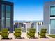 Rooftop patio featuring green chairs with mountain and city views at 55 W 12Th Ave # 510, Denver, CO 80204