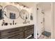 Updated bathroom featuring double sinks, modern lighting, and walk-in shower at 7865 E Mississippi Ave # 602, Denver, CO 80247