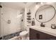 Renovated bathroom with a glass-enclosed shower, tile flooring, and modern vanity at 7865 E Mississippi Ave # 602, Denver, CO 80247