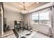 Cozy dining area with a bistro set, decorative chandelier, and window view at 7865 E Mississippi Ave # 602, Denver, CO 80247