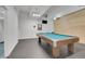 Game room with pool table, ceiling fan, mounted TV, and light wood accent wall at 7865 E Mississippi Ave # 602, Denver, CO 80247
