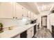 Well-lit kitchen with plenty of cabinet space, updated countertops, and new flooring at 7865 E Mississippi Ave # 602, Denver, CO 80247