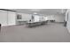 Spacious meeting room with tables, chairs, bright lighting, and neutral colored walls at 7865 E Mississippi Ave # 602, Denver, CO 80247