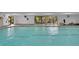 Bright indoor swimming pool with large windows that provide natural light and views of the trees and landscaping at 7865 E Mississippi Ave # 602, Denver, CO 80247