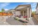This backyard is complete with a patio, chairs, grill, and low-maintenance gravel at 9635 Bellaire Ln, Thornton, CO 80229