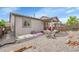 This backyard is complete with a patio, chairs, grill, and low-maintenance gravel at 9635 Bellaire Ln, Thornton, CO 80229