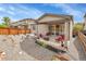The cozy backyard is complete with a patio, chairs, grill, and low-maintenance gravel at 9635 Bellaire Ln, Thornton, CO 80229