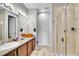 Modern bathroom featuring a spacious vanity, granite counters, and a glass-enclosed walk-in shower at 9635 Bellaire Ln, Thornton, CO 80229