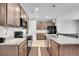 Spacious kitchen featuring stone countertops, ample cabinetry, and modern appliances at 9635 Bellaire Ln, Thornton, CO 80229