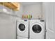 The laundry room features a side-by-side washer and dryer, and an open shelf for storage at 9635 Bellaire Ln, Thornton, CO 80229