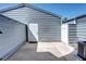 Private backyard patio with a door to the home, and low-maintenance white rock border at 1907 S Balsam St, Lakewood, CO 80227