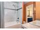 Stylish bathroom featuring a shower over tub, marble tile, and modern fixtures for a spa-like experience at 1907 S Balsam St, Lakewood, CO 80227