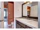 Stylish bathroom with elegant vanity, modern fixtures, and adjacent rooms leading to the toilet and shower stall at 1907 S Balsam St, Lakewood, CO 80227