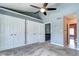 Spacious bedroom with high ceilings, plush carpeting, ceiling fan and access to ensuite bath and hallway at 1907 S Balsam St, Lakewood, CO 80227