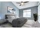 Serene bedroom with a vaulted ceiling, large window, neutral tones, and a ceiling fan at 1907 S Balsam St, Lakewood, CO 80227