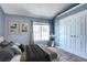 Comfortable bedroom with ample natural light, plush bedding, and a double-door closet at 1907 S Balsam St, Lakewood, CO 80227