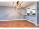 Dining room with hardwood floors and view into kitchen with stainless steel appliances at 1907 S Balsam St, Lakewood, CO 80227