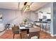 Elegant dining room featuring modern lighting, stylish seating, and a convenient pass-through to the kitchen at 1907 S Balsam St, Lakewood, CO 80227