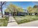 Charming townhome with beautiful landscaping and a welcoming front porch and entryway on a sunny day at 1907 S Balsam St, Lakewood, CO 80227