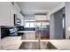 Updated kitchen features white cabinets, stainless steel appliances and marble counter top with stylish backsplash at 1907 S Balsam St, Lakewood, CO 80227