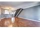 Living room with hardwood floors, adjacent kitchen, and staircase at 1907 S Balsam St, Lakewood, CO 80227