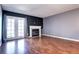 Spacious living room showcasing hardwood floors, fireplace, and access to back patio at 1907 S Balsam St, Lakewood, CO 80227