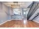 Open-concept living room featuring hardwood floors and modern light fixture adjacent to kitchen at 1907 S Balsam St, Lakewood, CO 80227