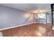 Open-concept living room showcasing hardwood floors, view to kitchen and staircase at 1907 S Balsam St, Lakewood, CO 80227