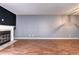 Spacious living room showcasing hardwood floors and fireplace with white mantle at 1907 S Balsam St, Lakewood, CO 80227
