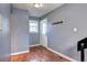 Functional mudroom with hardwood floors, convenient coat hooks, and natural light from the window at 1907 S Balsam St, Lakewood, CO 80227