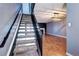 View of staircase that leads to an open living area with fireplace at 1907 S Balsam St, Lakewood, CO 80227