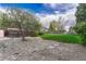 Lush backyard space with a mature tree, gravel groundcover, partial grass and stepping stones at 7425 S Dexter St, Centennial, CO 80122