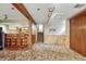 View of the finished basement with bar, wood accents, and carpeting at 7425 S Dexter St, Centennial, CO 80122