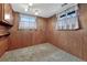 Cozy bedroom with wood paneled walls, carpeting, and ample natural light from the windows at 7425 S Dexter St, Centennial, CO 80122