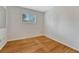 Bright, empty bedroom with wood flooring and a window at 7425 S Dexter St, Centennial, CO 80122