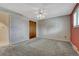 Carpeted bedroom features a closet and ceiling fan at 7425 S Dexter St, Centennial, CO 80122